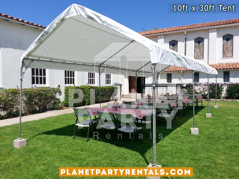 10x30 Tent with Rectangular Tables and Plastic White Chairs setup on grass