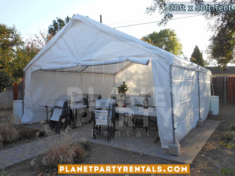 20 x 20 Tent with Side panels, white rectangular tables and white Plastic Chairs on Cement 